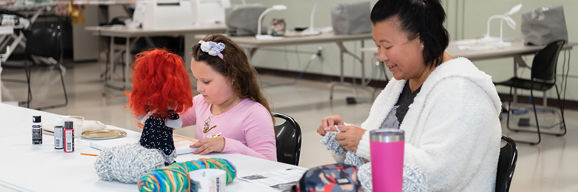 Woman and girl using the creation space to craft